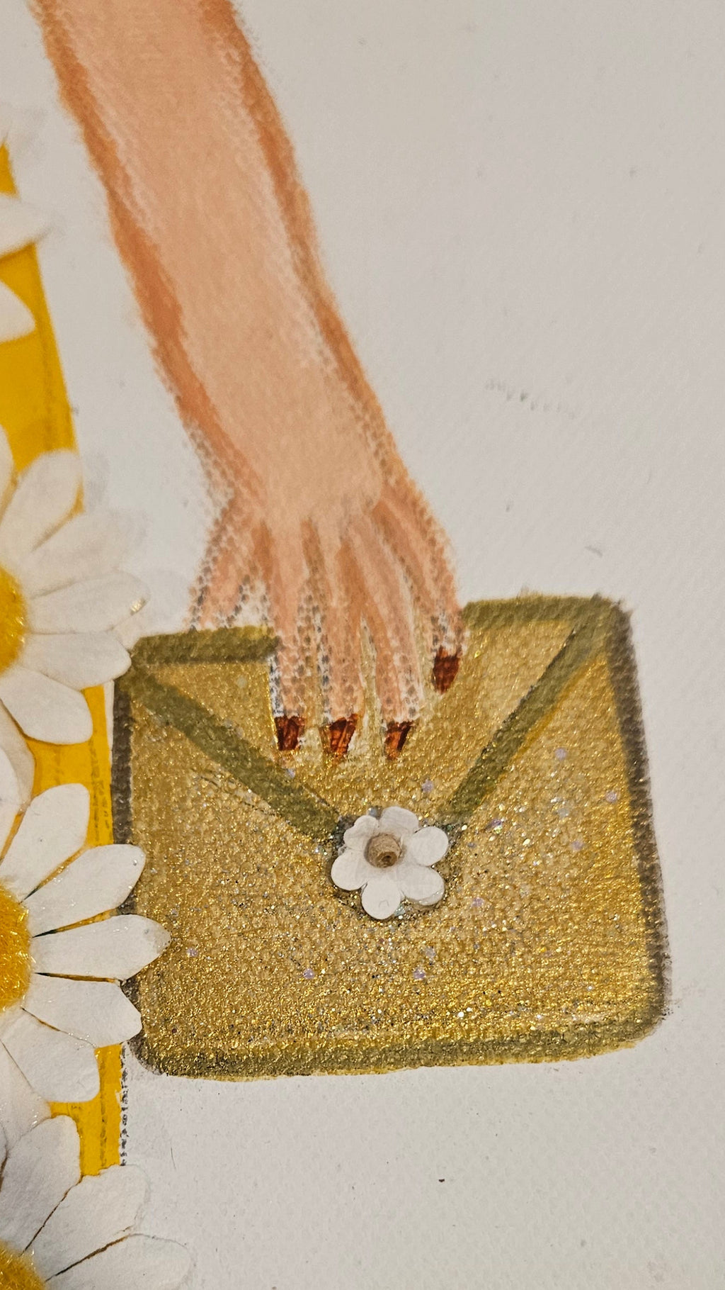 Embroidery of a hand holding a box with flowers and daisies on a white background