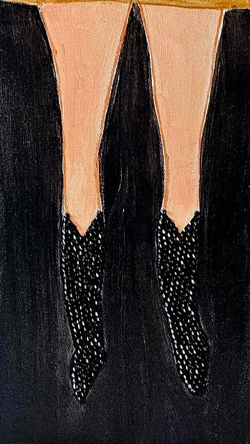 Close-up of black shoes with peep-toe design on a dark background