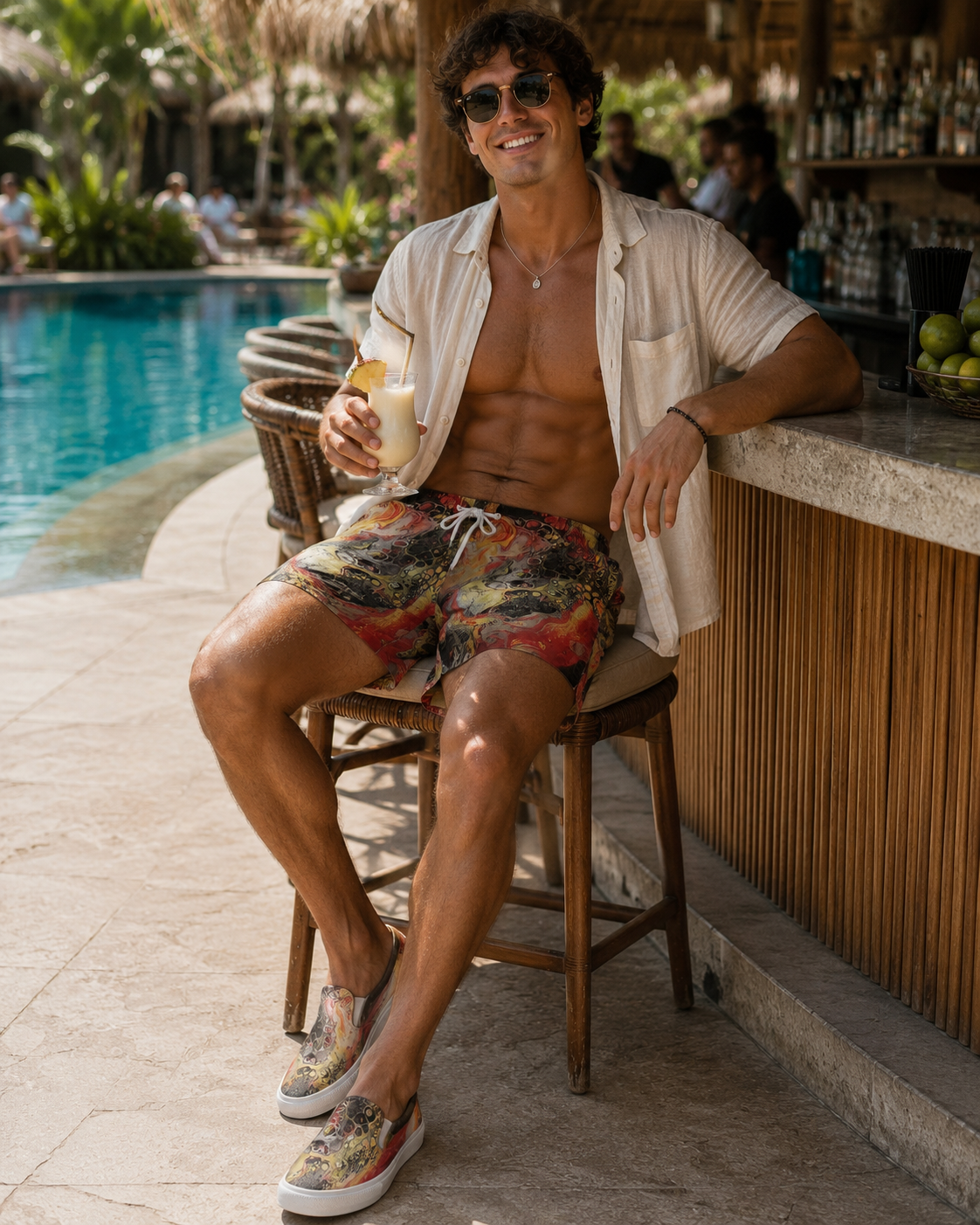 


Man sitting by a poolside bar holding a drink