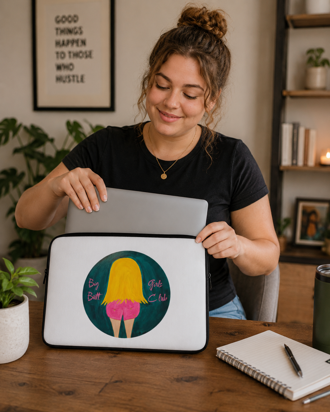 Woman holding a laptop with a colorful design on a wooden desk