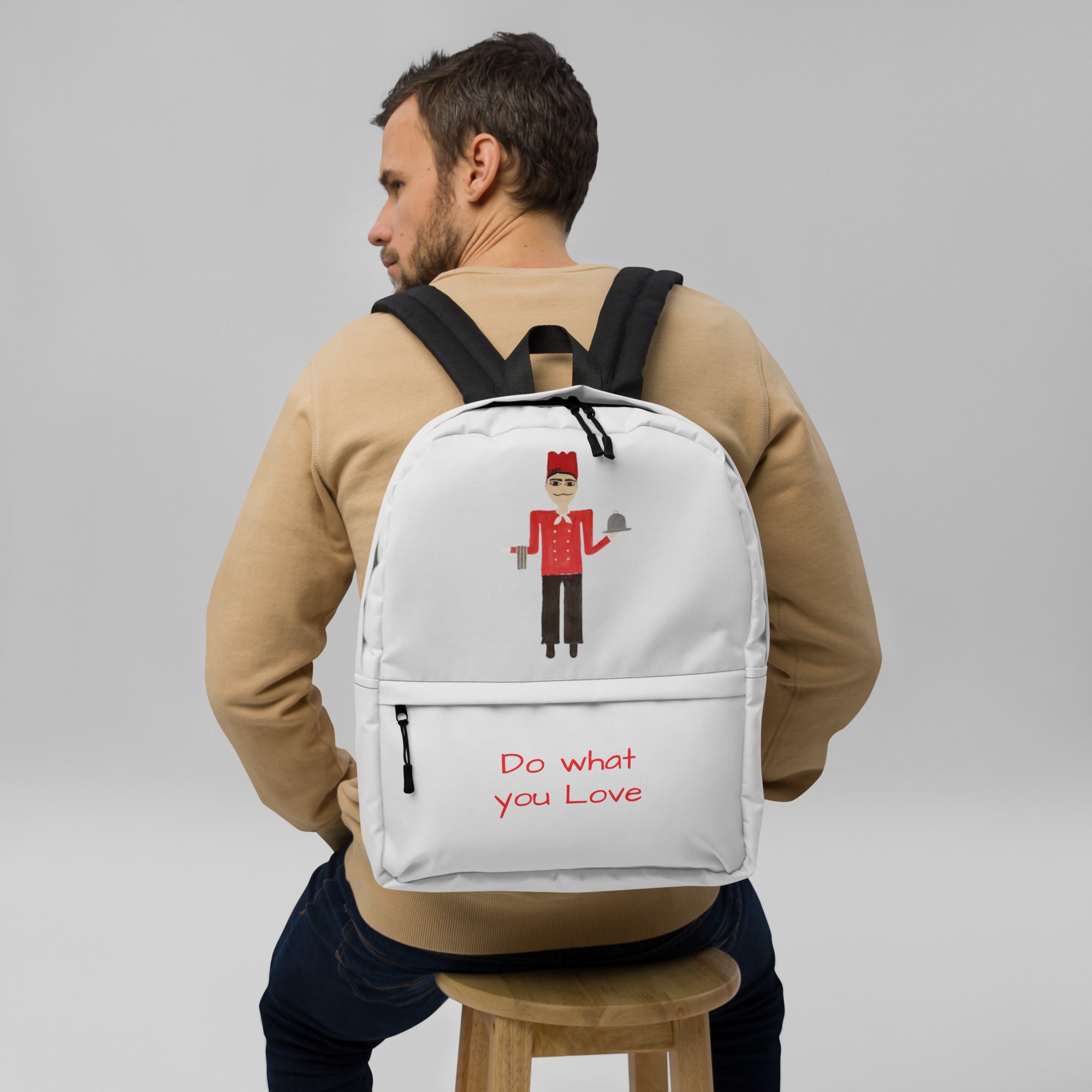 Man wearing a white backpack with 'Valuble' branding on a gray background