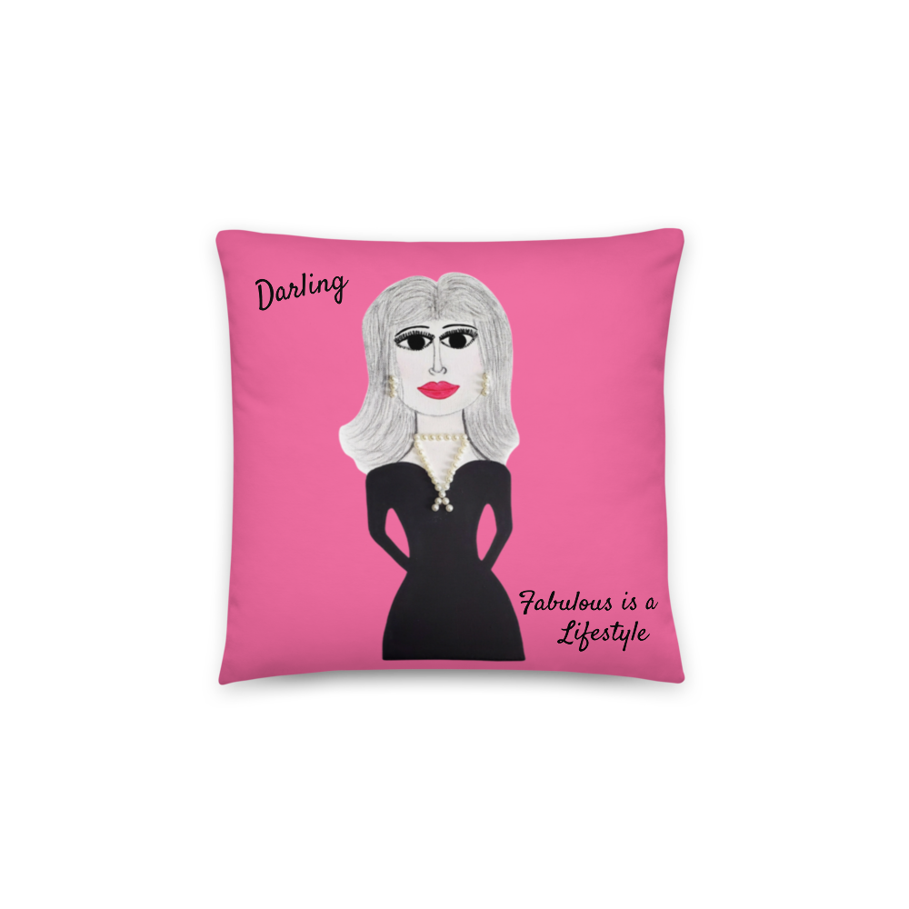 A square pink throw pillow featuring a stylized illustration of a woman with gray hair, a black dress, and red lips, with the text 'Darling' and 'Fabulous is a Lifestyle' on a white background.