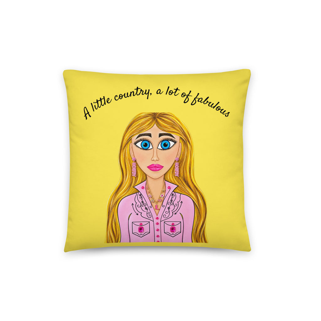 A square yellow throw pillow featuring a cartoon illustration of a blonde woman in a pink shirt and the text 'A little country, a lot of fabulous' in black script.
