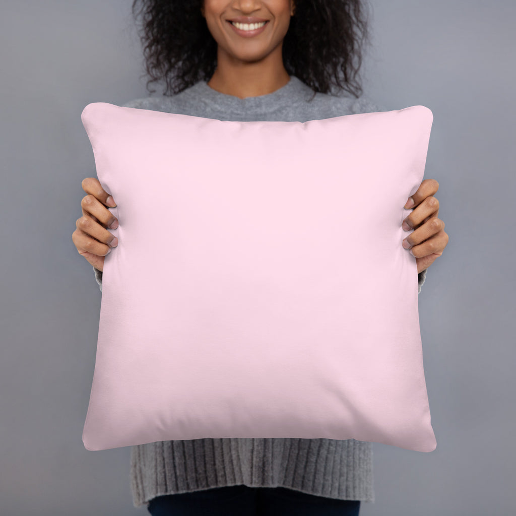 Person holding a white pillow against a gray background