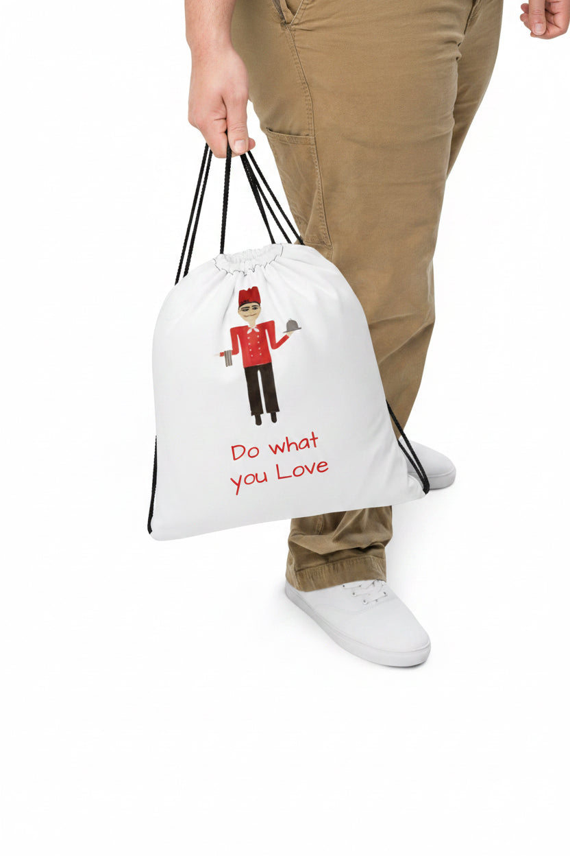 Person holding a white drawstring bag with an illustration and text on a white background