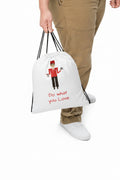 Person holding a white drawstring bag with an illustration and text on a white background