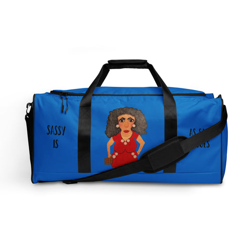 Blue duffel bag with a cartoon character and 'Sassy is' text on a white background