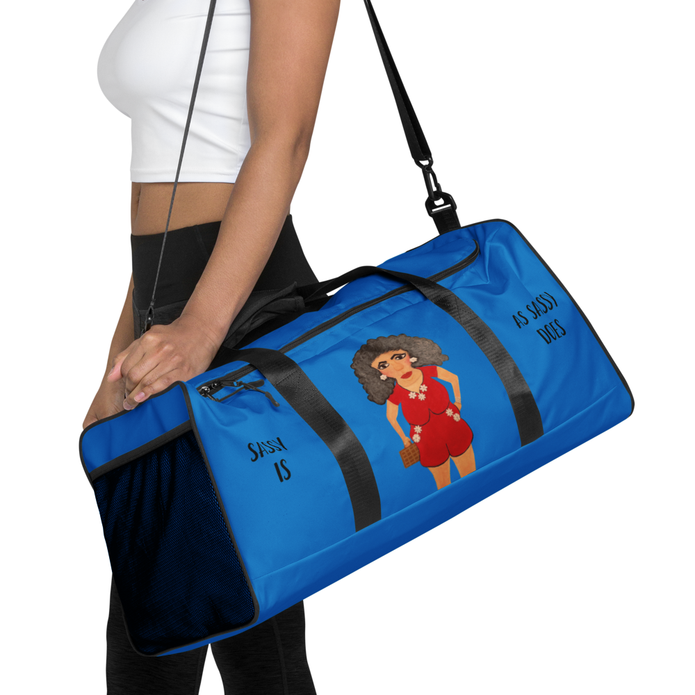 Blue duffel bag with a cartoon character and text held by a person on a white background