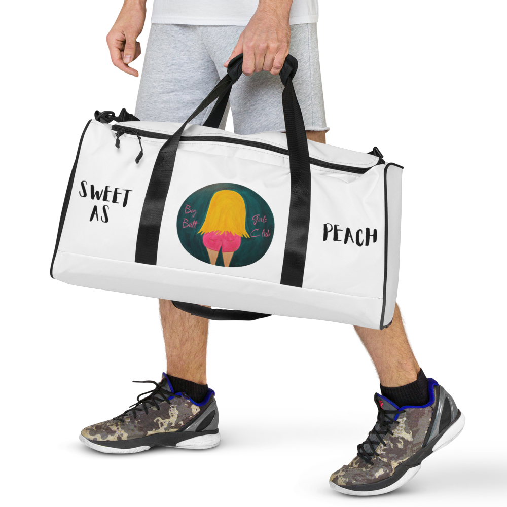 Person holding a white duffel bag with a colorful graphic and text on a white background