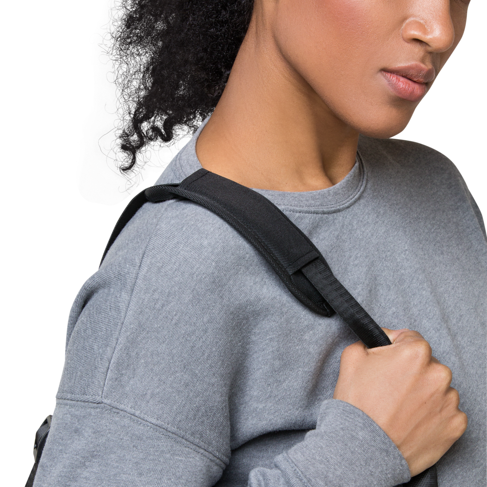 Person wearing a gray sweatshirt with a black strap over their shoulder on a white background