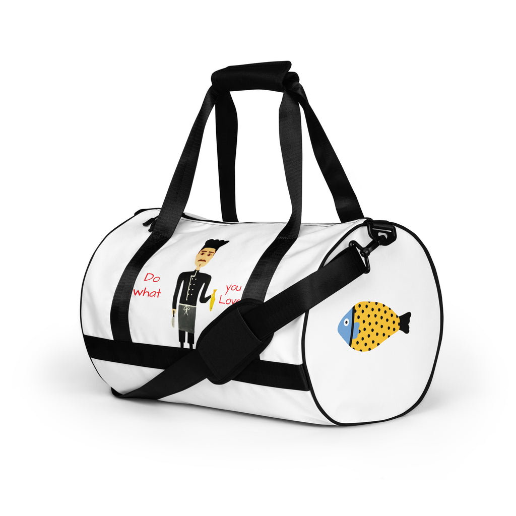 White duffel bag with black straps featuring a cartoon character and fish design on a white background