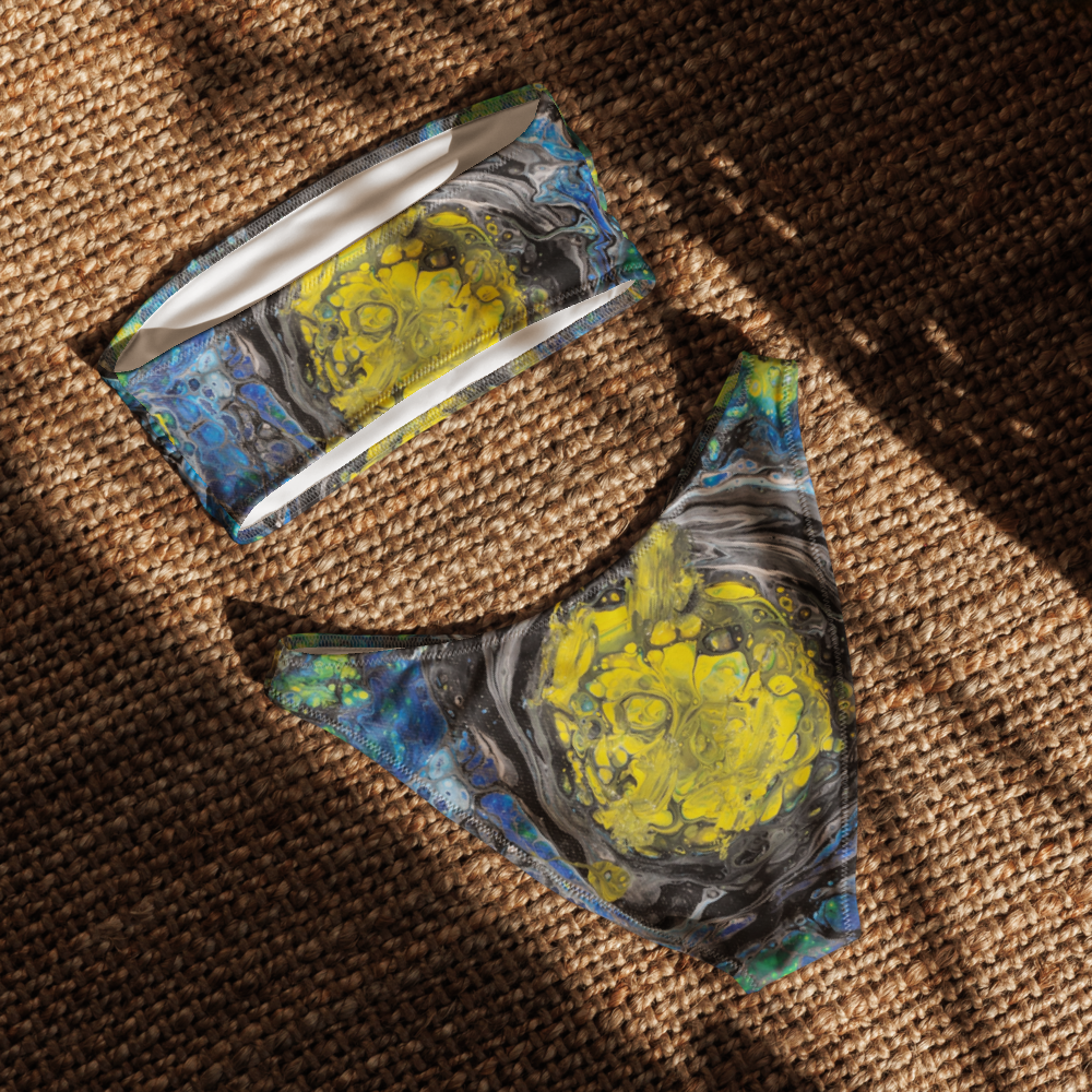Bikini set with abstract design featuring yellow and blue patterns on a white background