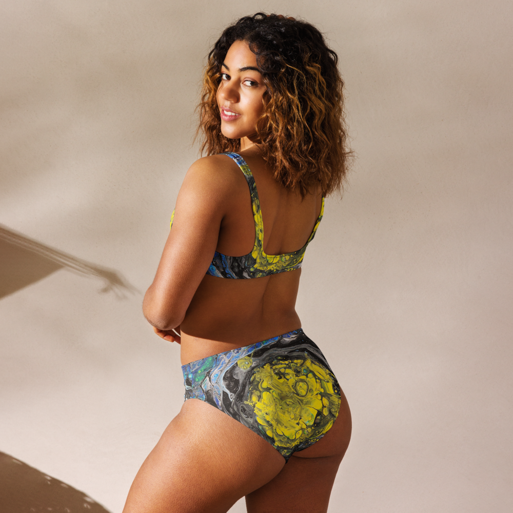 Woman wearing a colorful bikini set against a neutral background
