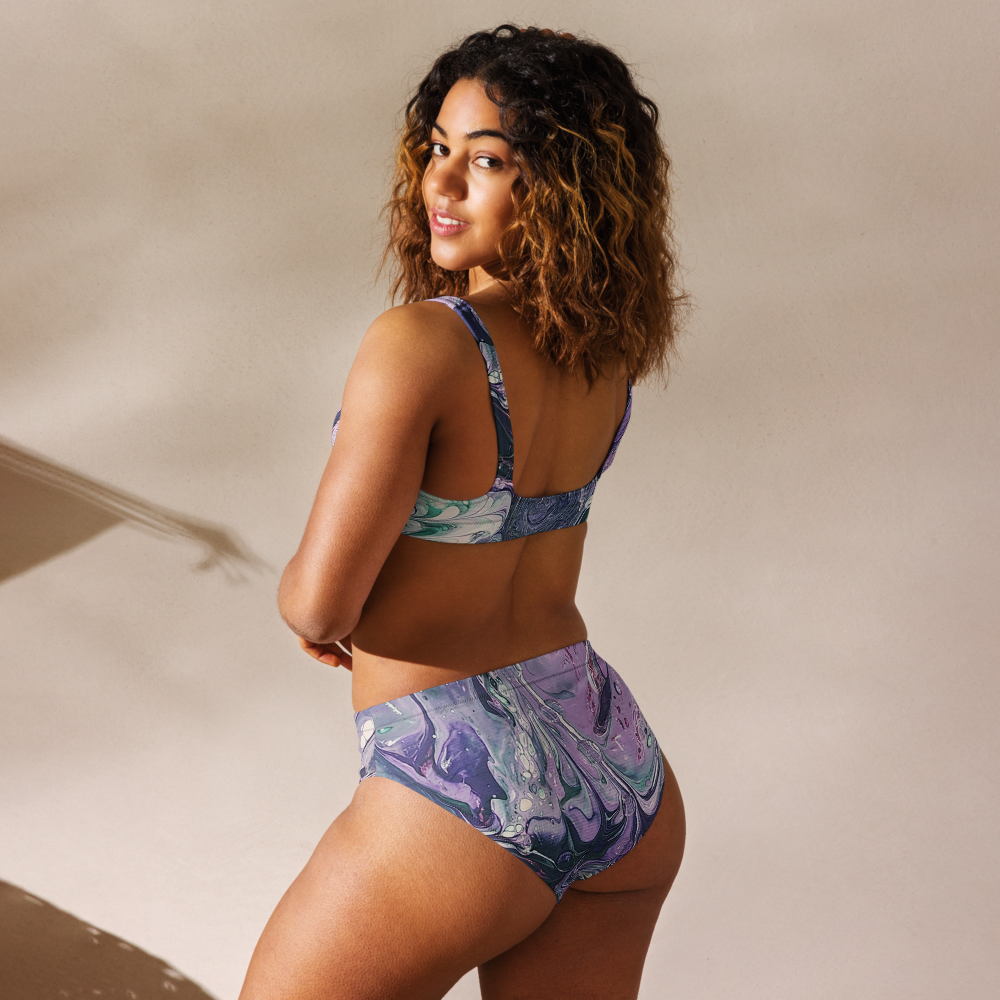 Woman wearing a colorful bikini set against a neutral background