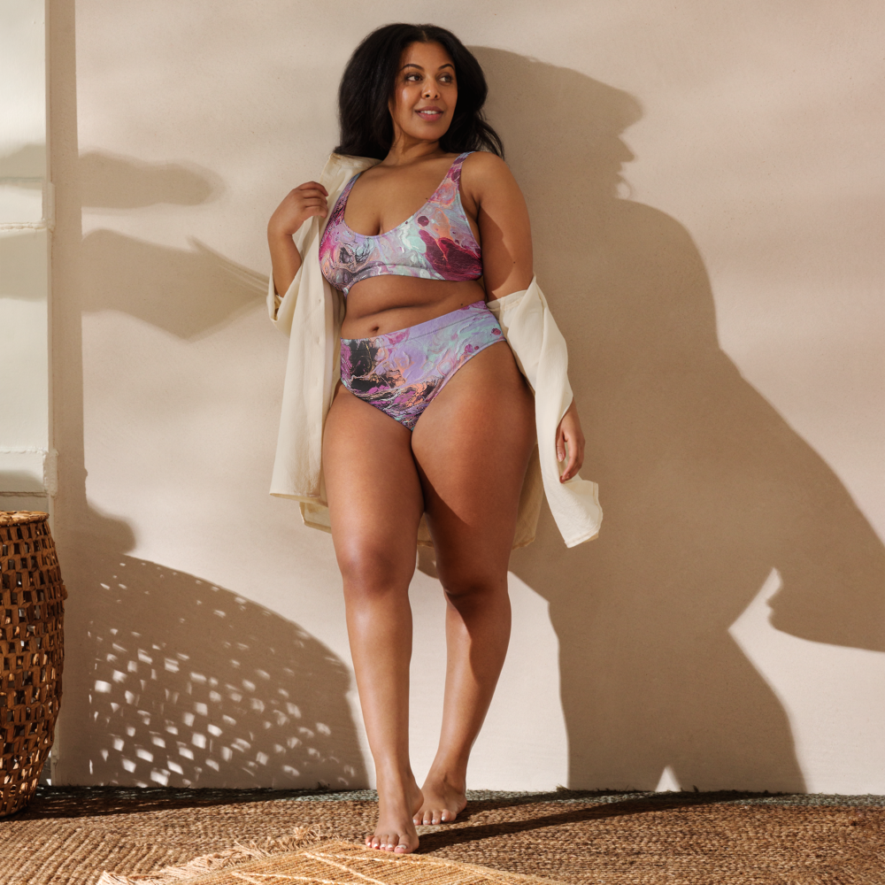 Woman wearing a colorful bikini standing against a neutral wall with a woven basket in the corner.