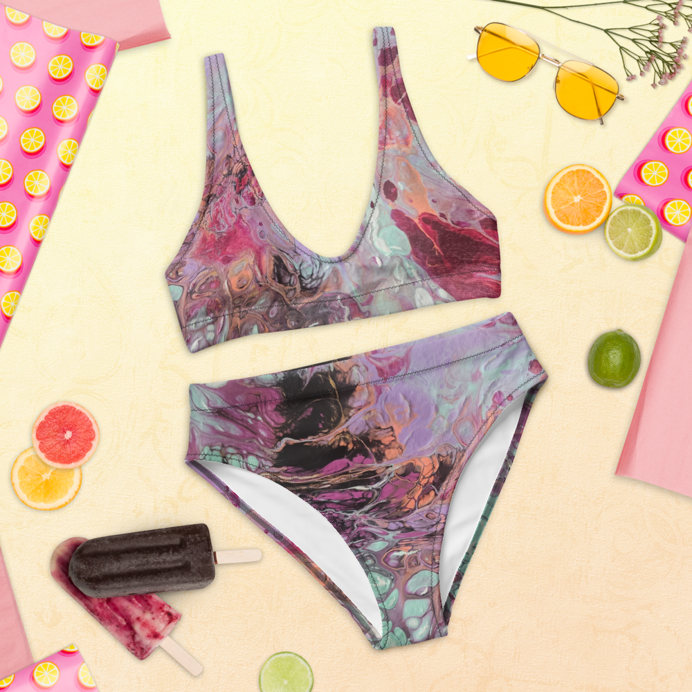Colorful swimsuit with sunglasses, fruit slices, and a popsicle on a yellow background