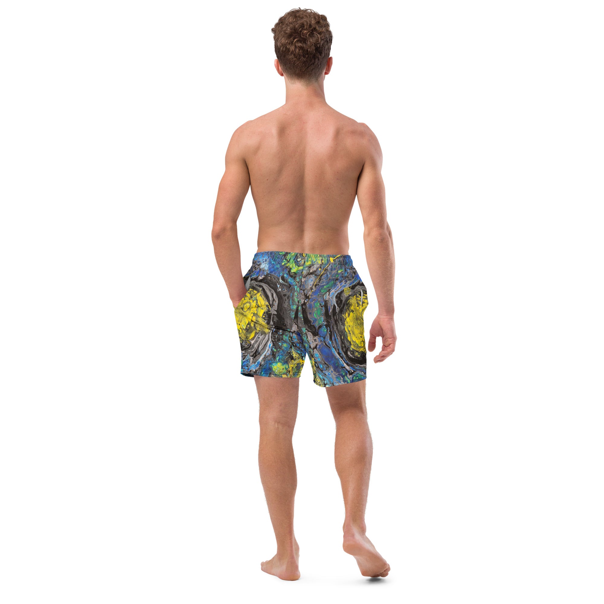 Man wearing colorful swim shorts on a white background