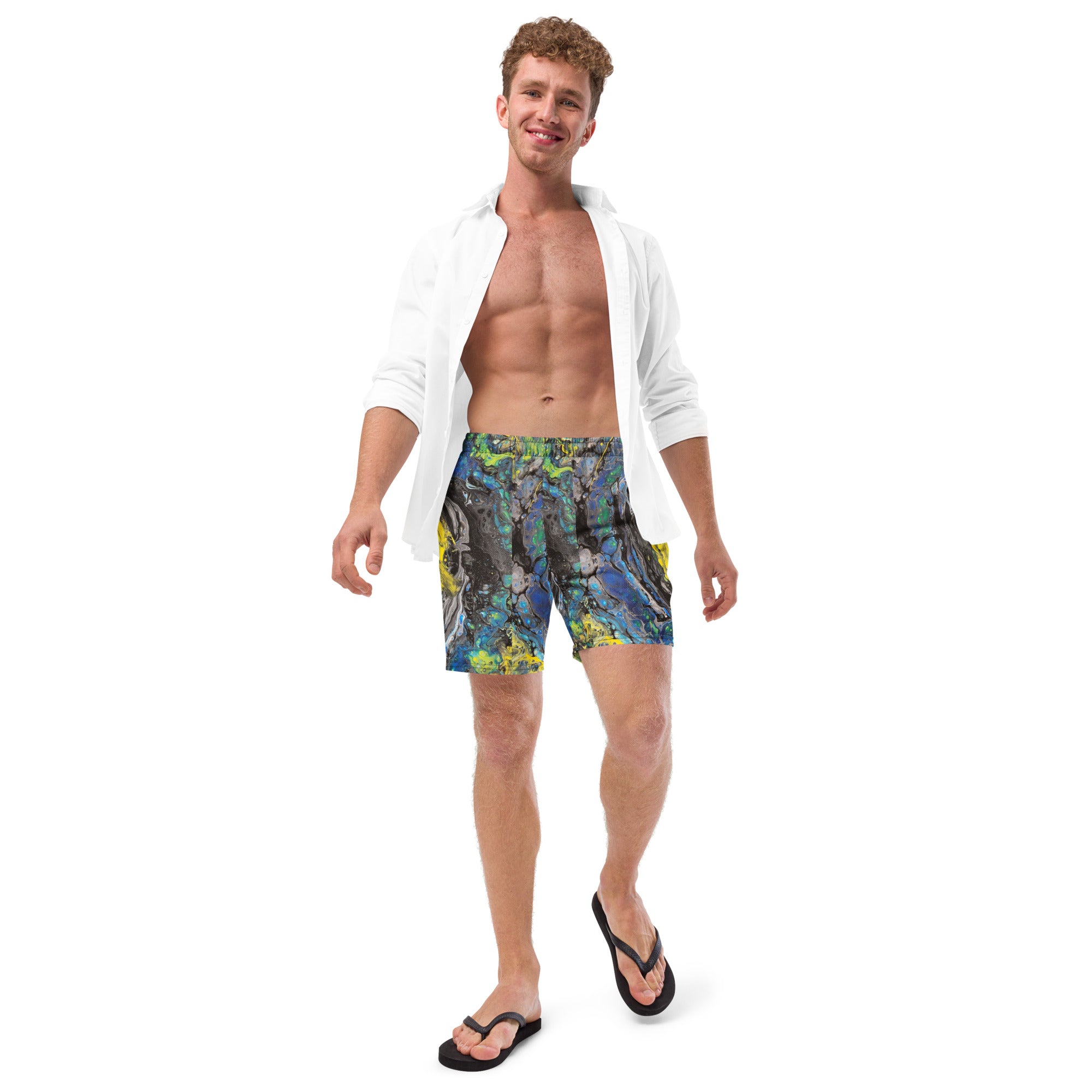 Man wearing colorful swim shorts and a white shirt on a white background