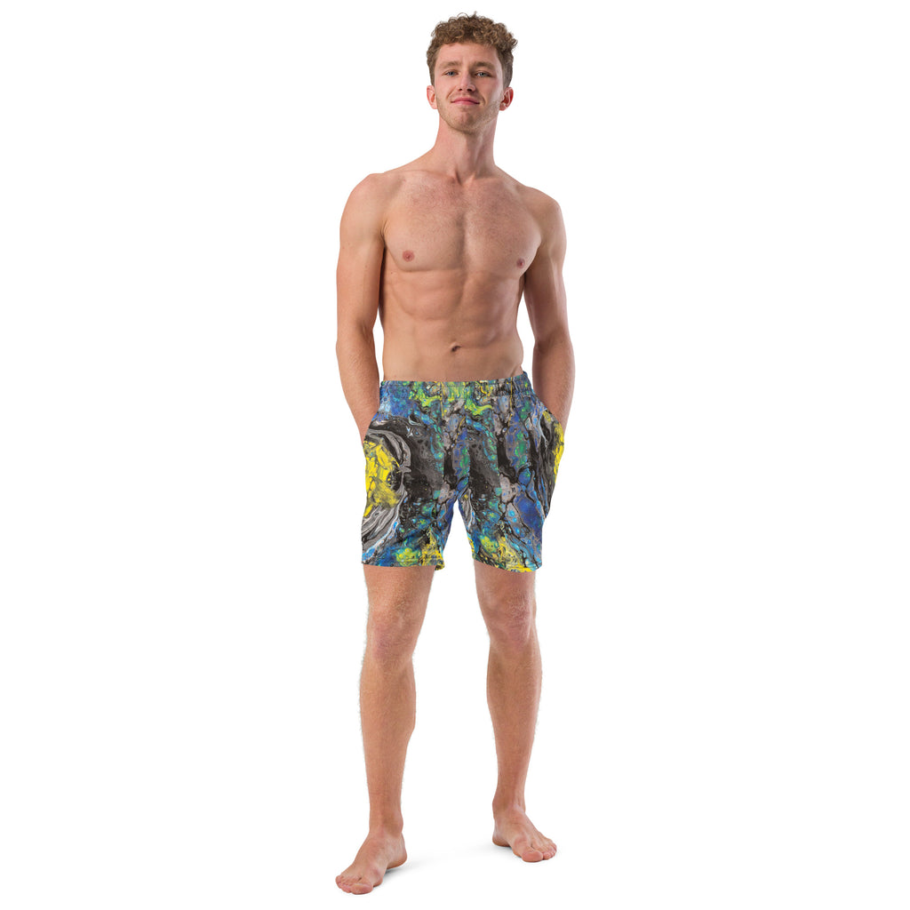 Man wearing colorful swim shorts on a white background