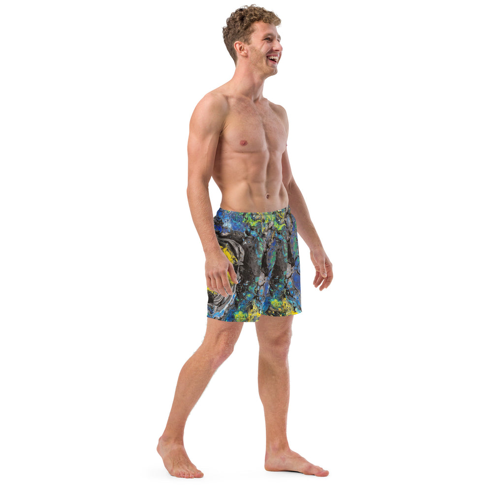 Man wearing colorful swim shorts on a white background
