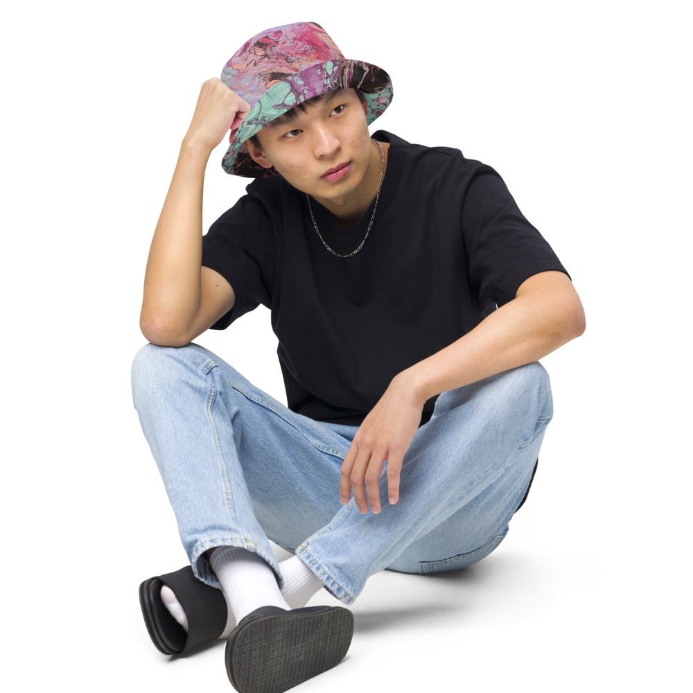 Person wearing a colorful bucket hat, black t-shirt, blue jeans, and black shoes on a white background