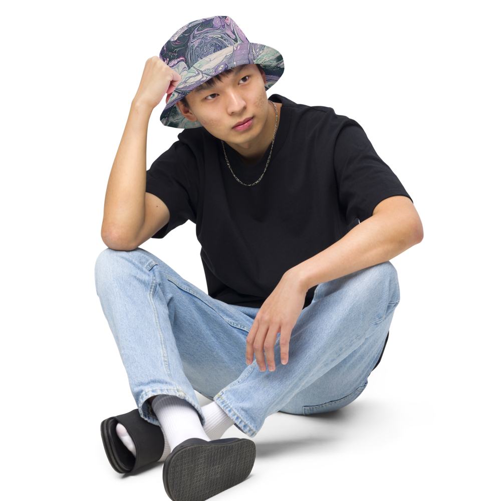 Person wearing a black t-shirt, light blue jeans, and a patterned hat on a white background