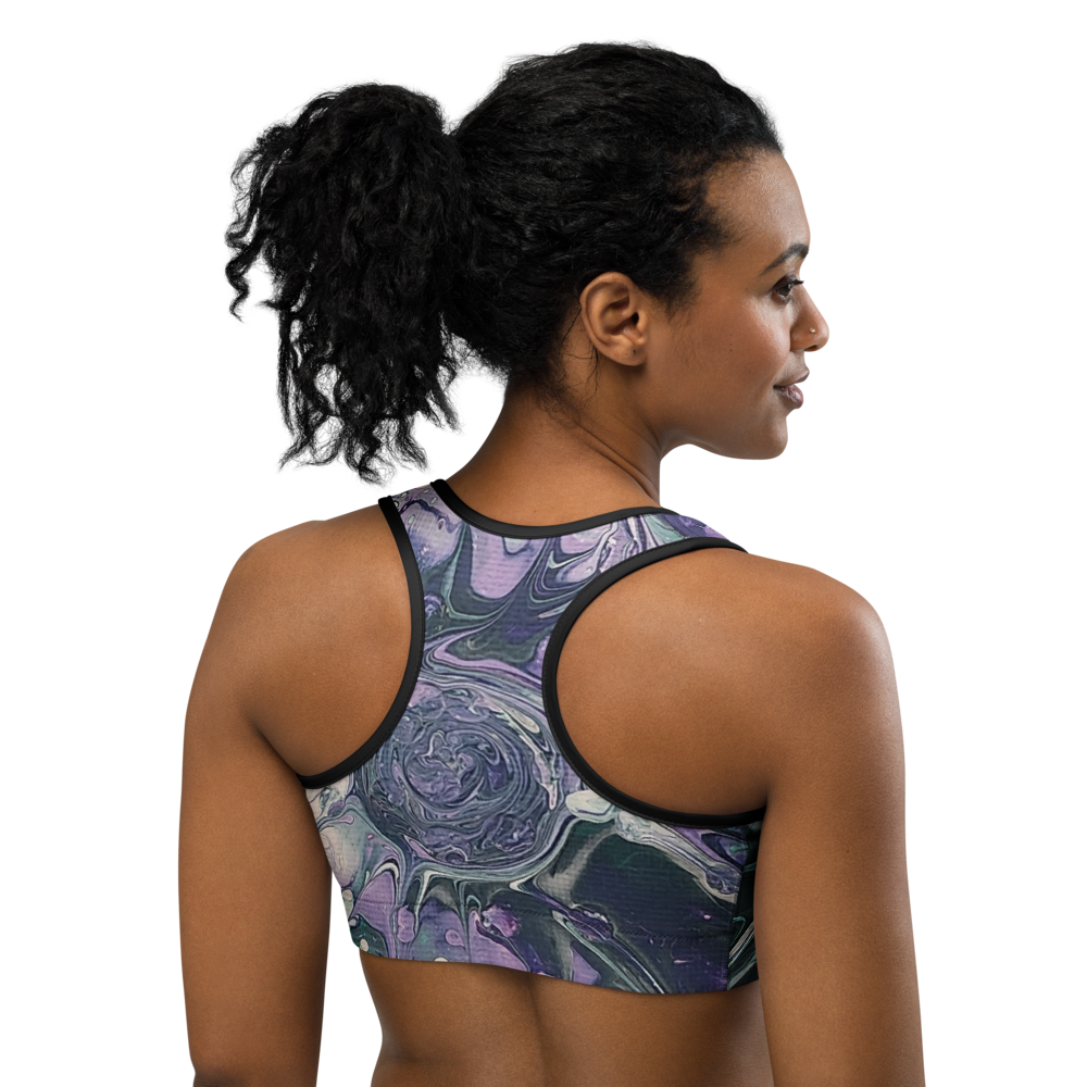Woman wearing a sports bra with a colorful abstract design on a white background