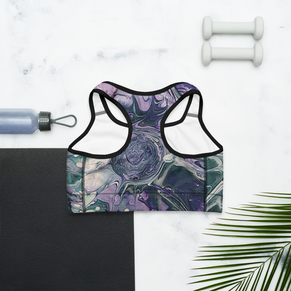 Marbled patterned sports bra on a white background with a yoga mat, water bottle, and dumbbells.