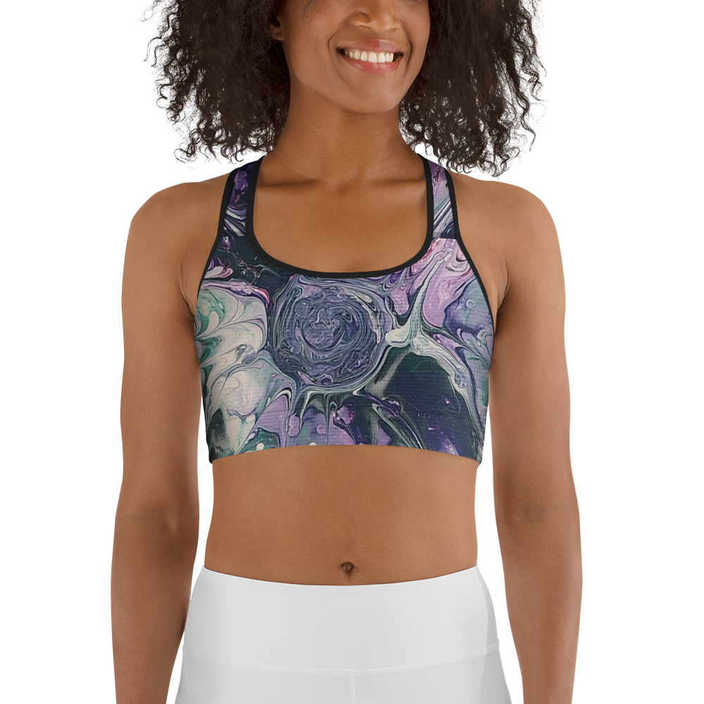 Woman wearing a sports bra with a colorful abstract design on a white background