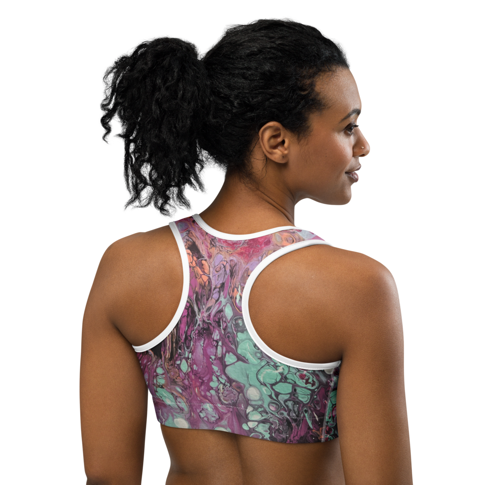Woman wearing a colorful sports bra with white straps on a white background