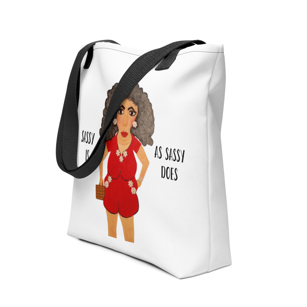 White tote bag with a graphic of a woman in a red outfit and text 'Sassy is as sassy does' on a white background.