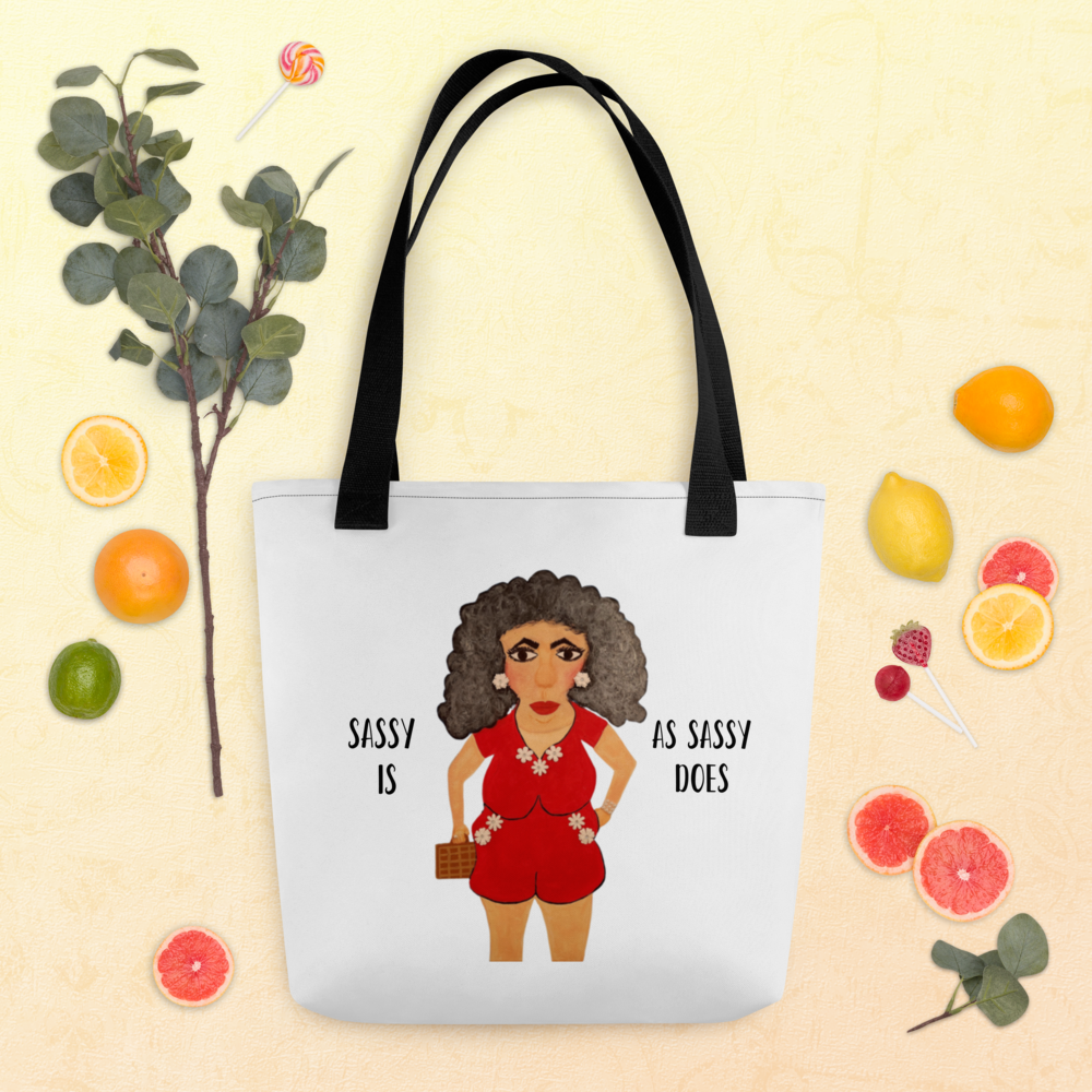Tote bag with a graphic of a woman in a red outfit and text, surrounded by fruits and plants on a beige background.