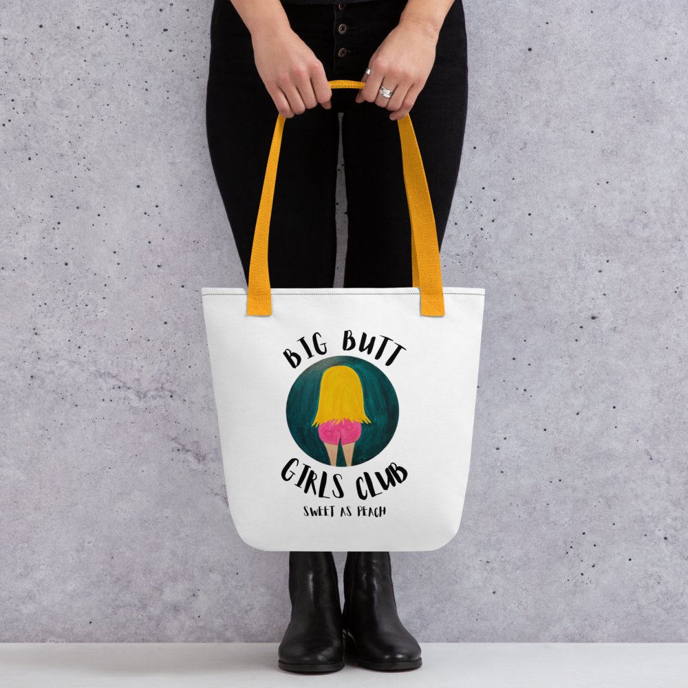 Tote bag with 'Big Butt Girls Club' design held by a person against a gray background