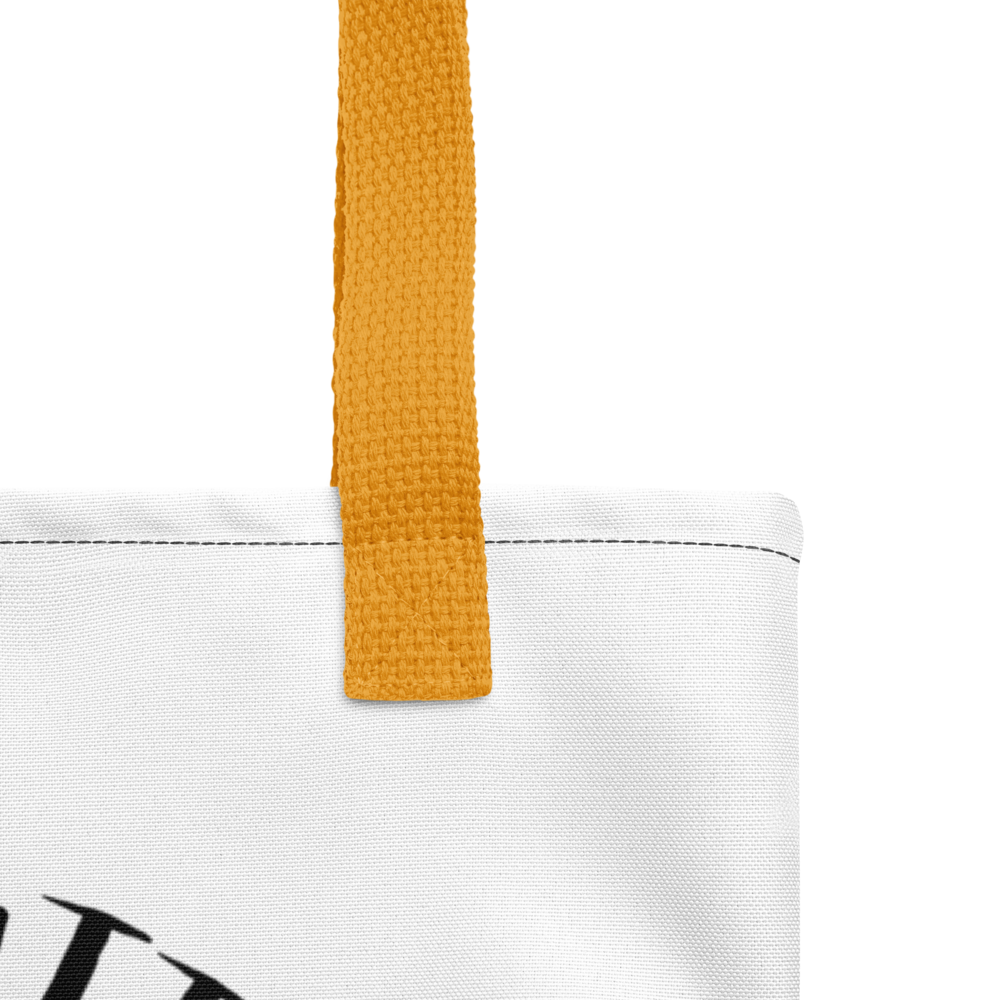 Close-up of a white tote bag with a mustard yellow strap on a white background