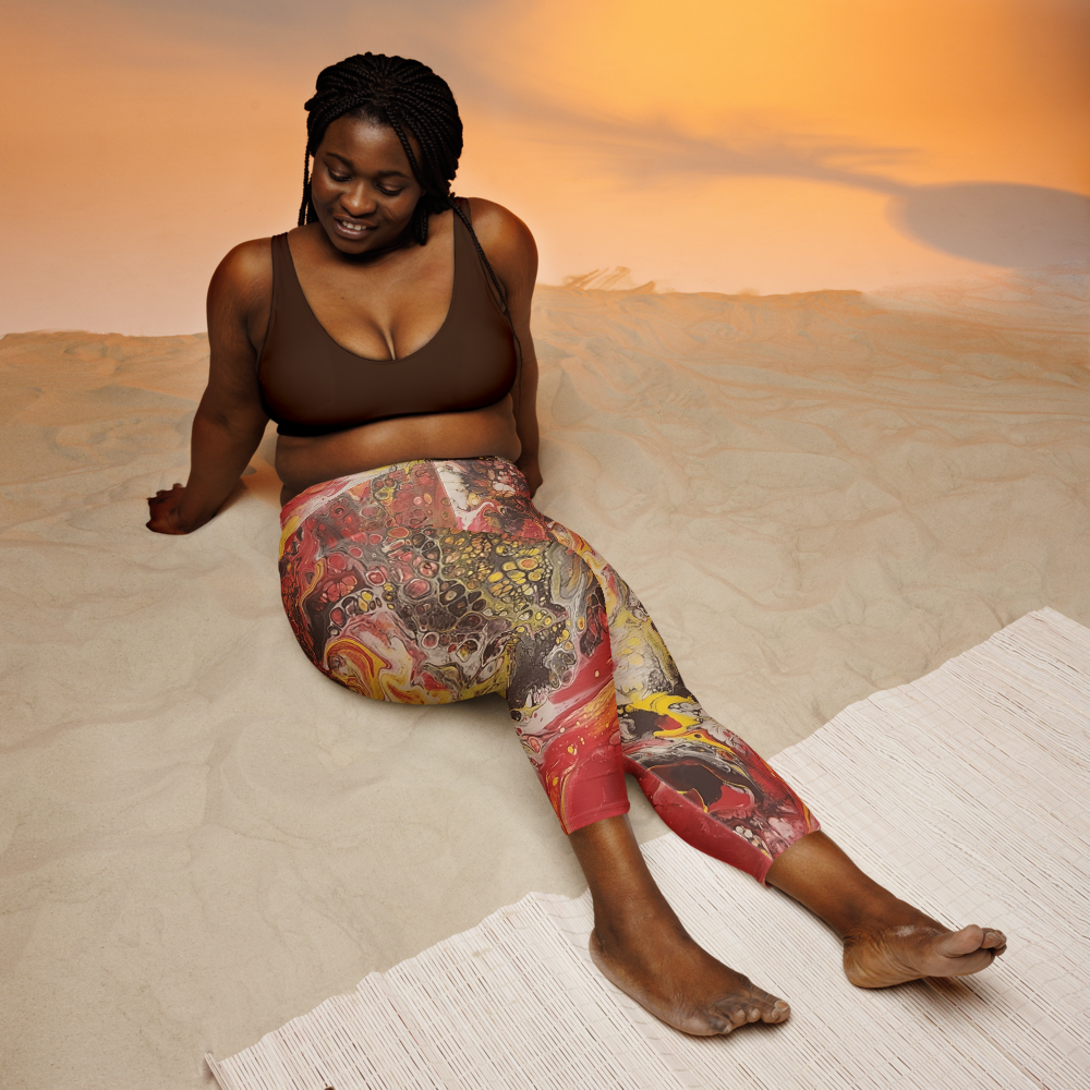 woman sitting in the sand wearing yoga pants
