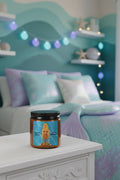 An amber glass jar candle with a black lid and a colorful label featuring a mermaid illustration and the text 'Beach Breeze' and 'I'm a Mermaid!'.