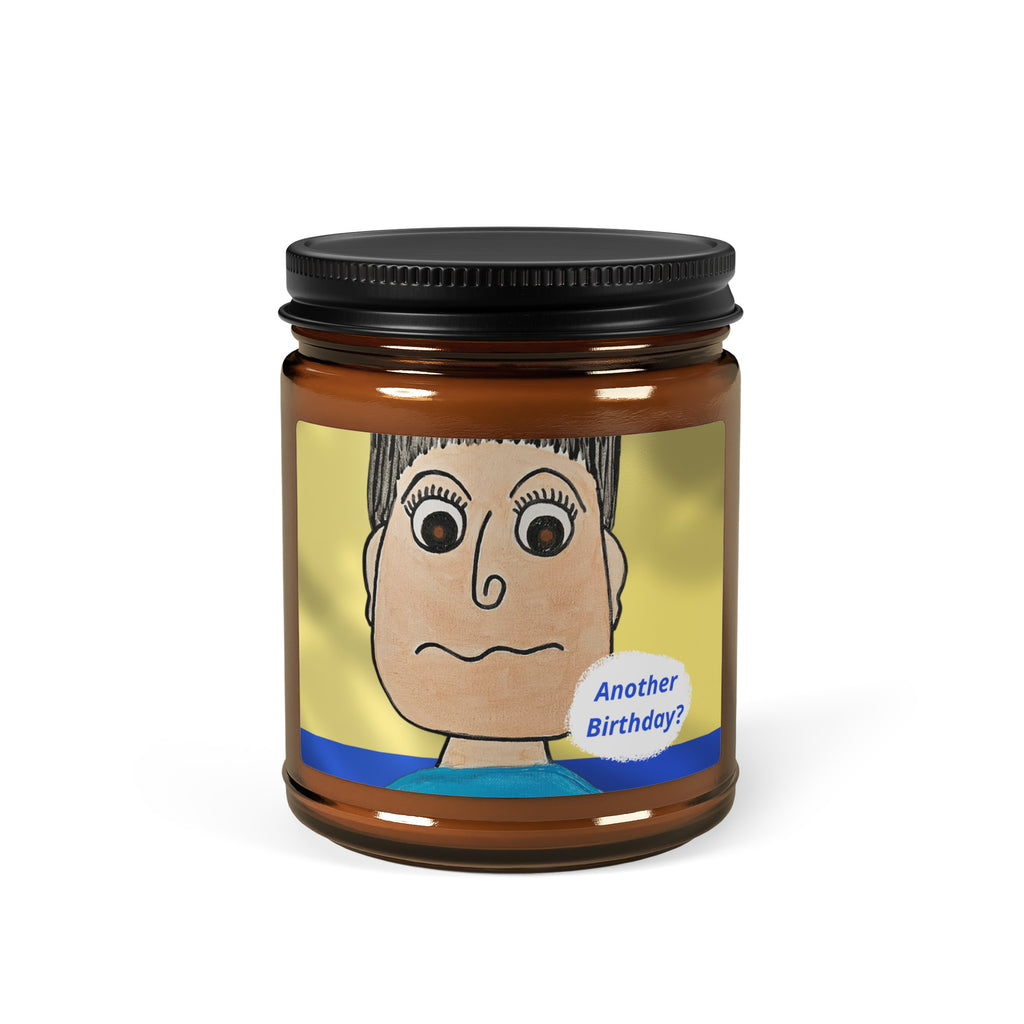 Candle jar with a cartoon label featuring a face and 'Another Birthday!' text on a white background