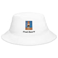 A white bucket hat with a small graphic print on the front showing a cartoon figure and the text 'Just Don't!' in black, photographed against a light gray background.