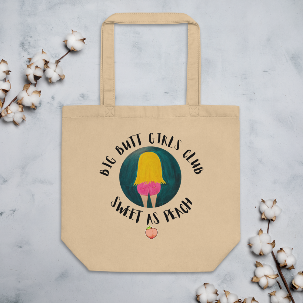 Beige tote bag with 'Big Butt Girls Club Sweet as Peach' design on a light gray background with cotton branches.