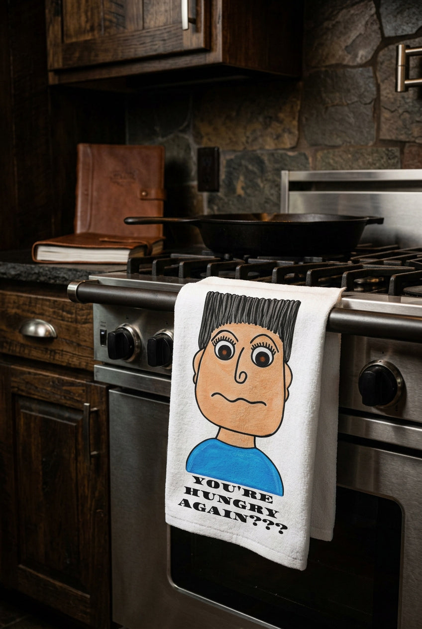 whimsical character kitchen hand towel hanging on a stove in a kitchen