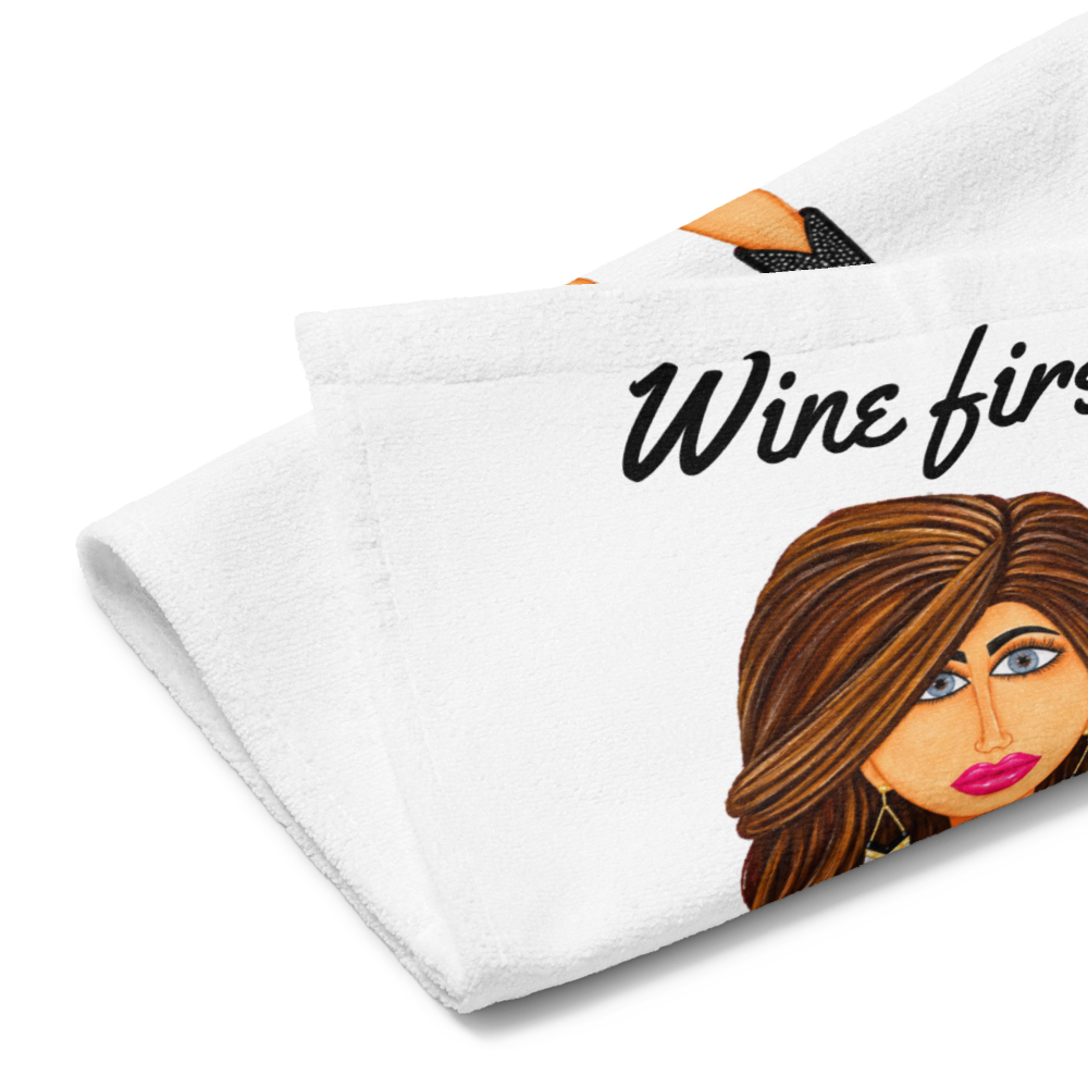 side view of a kitchen hand towel with a whimsical character holding a glass of wine on a white background