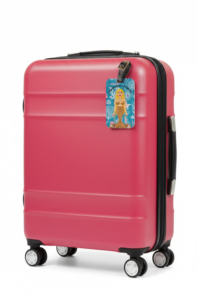 picture of a pink suitcase with a mermaid luggage tag