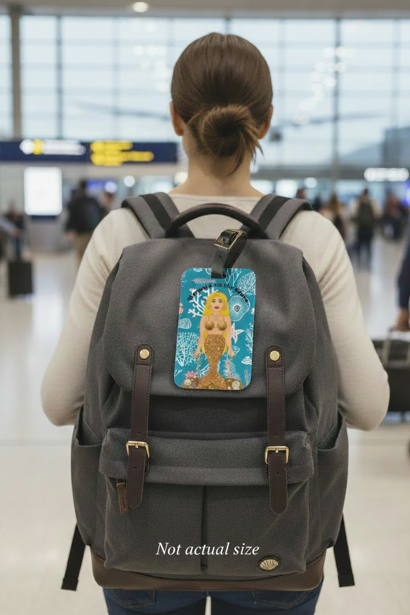 a picture of woman with a backpack on her back with a mermaid luggage tag