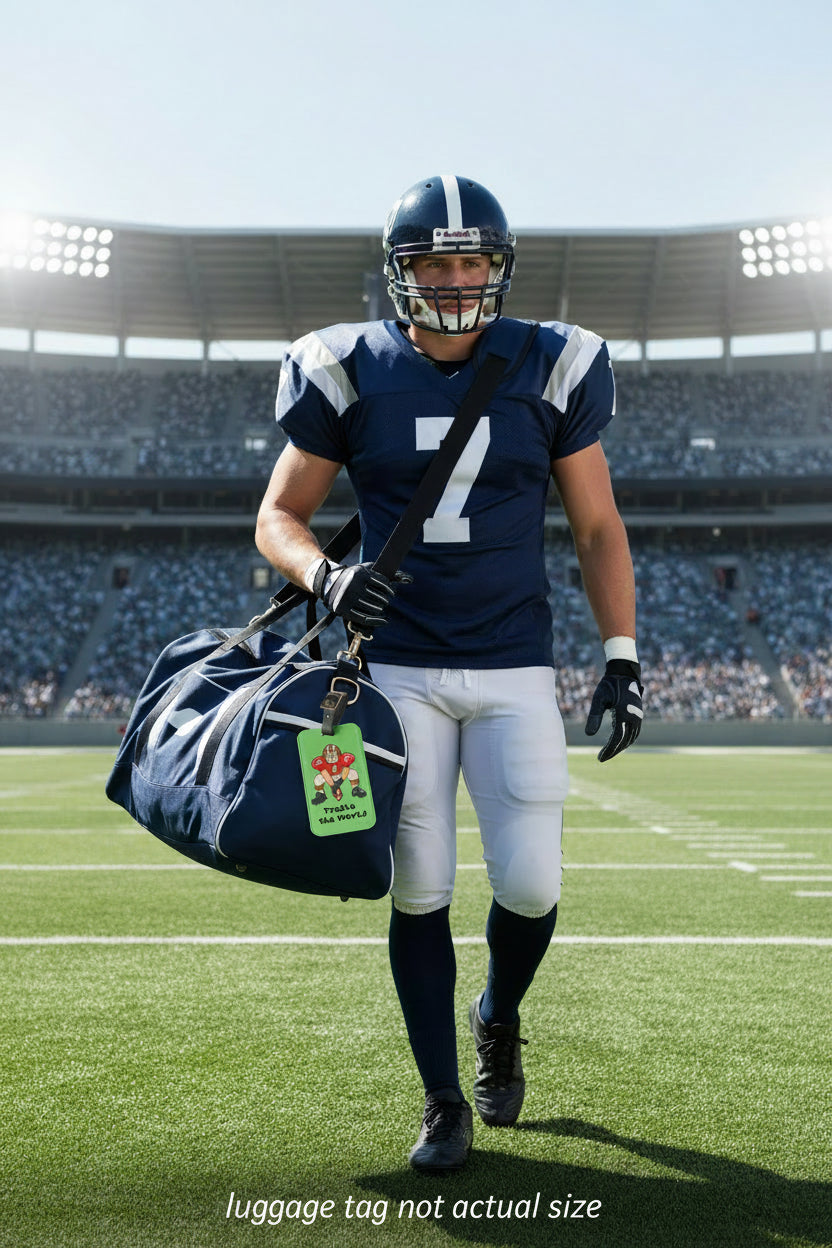 A green luggage tag with a black strap and gold buckle, featuring a cartoon football player graphic and the text 'Tackle the World' on a white background.
