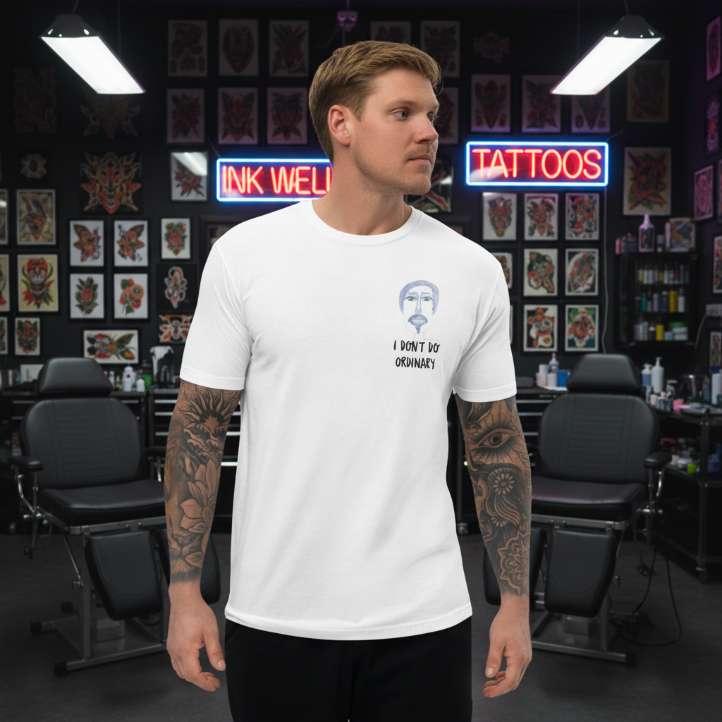a tattooed man wearing a black, whote and green t-shirt in a tattoo parlor