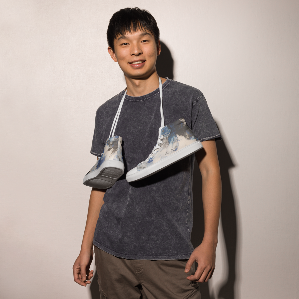 Person holding two sneakers over their shoulders against a plain background