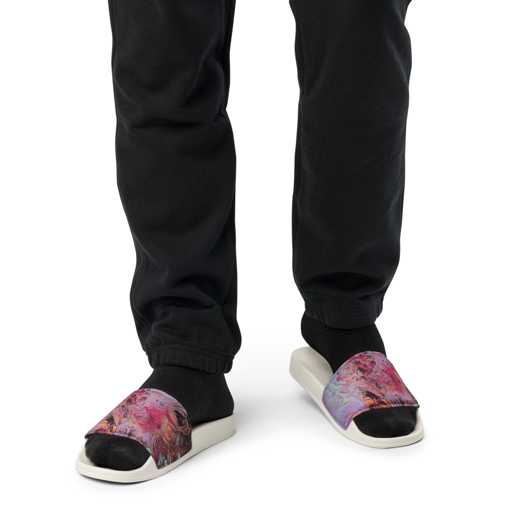 Person wearing colorful sandals with black pants on a white background