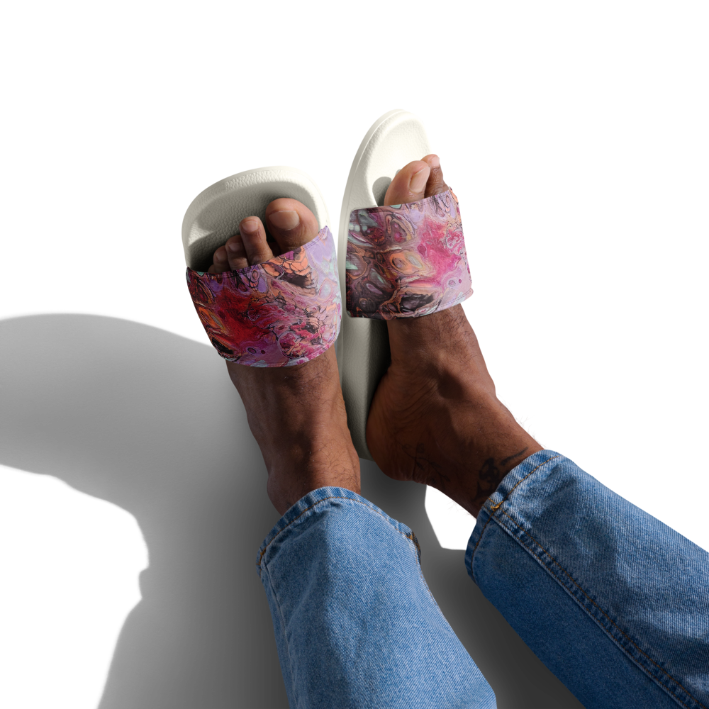 Colorful sandals with abstract design worn by a person on a white background