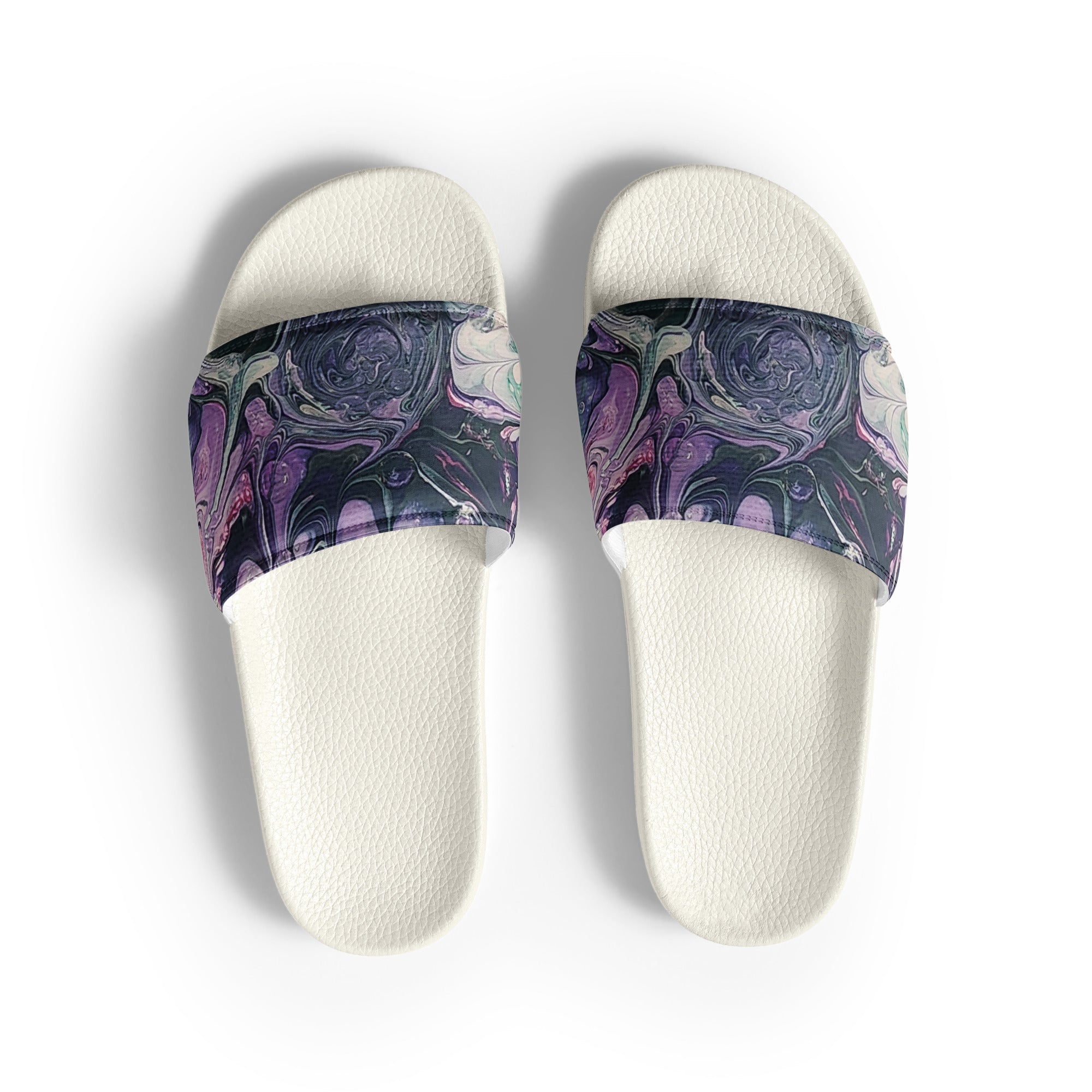 Pair of white slides with purple and blue marbled straps on a light gray background