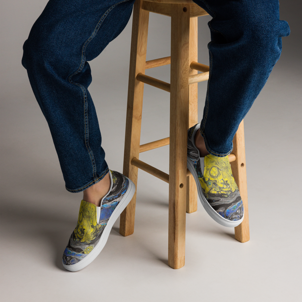 Person wearing colorful sneakers with abstract designs on a wooden stool.